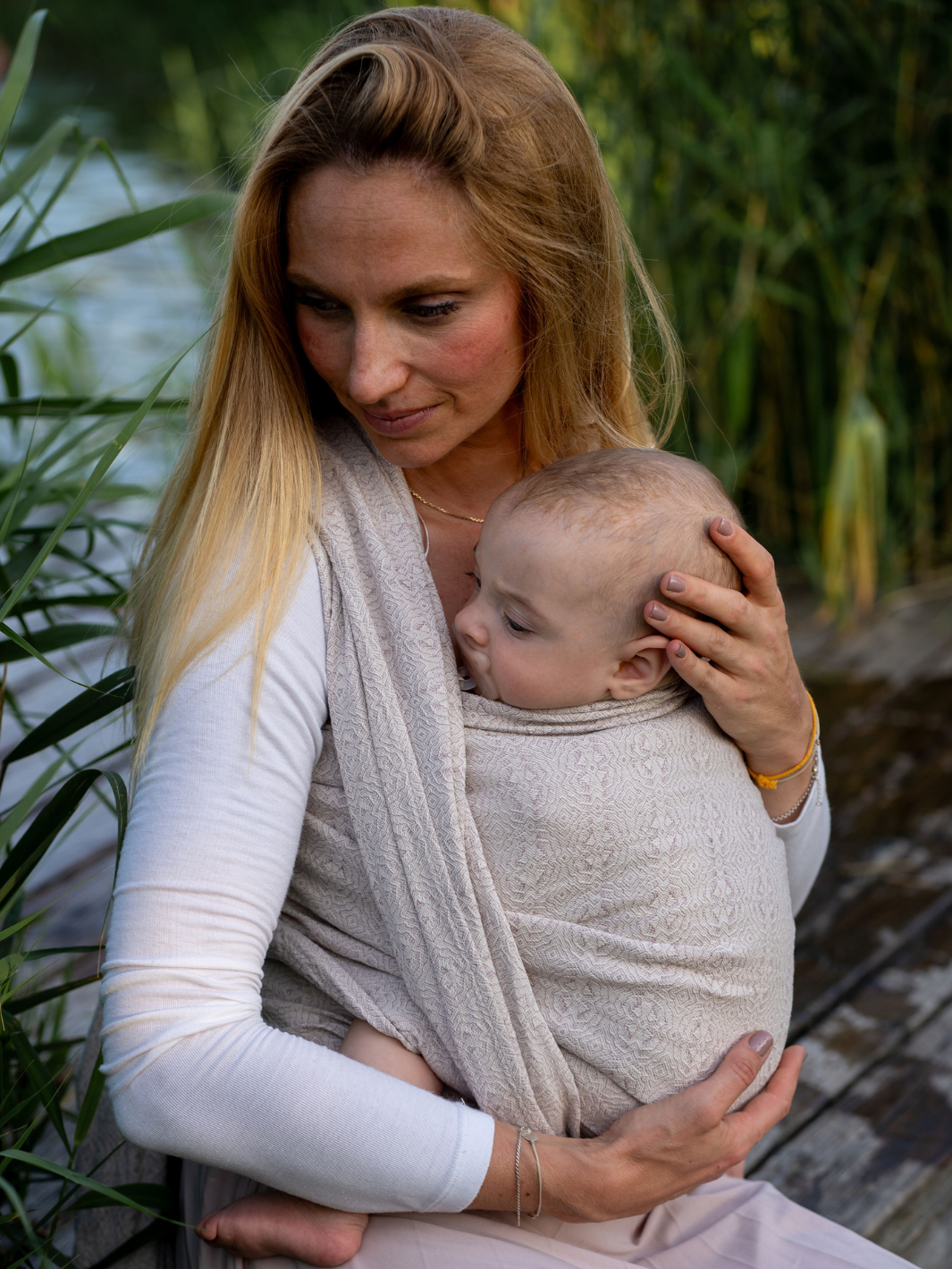Schlafendes Baby am Wasser, Nahaufnahme mit Schilf